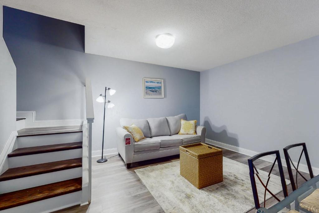 a living room with a couch and a staircase at 37898 Eagle Lane unit #344 in Selbyville