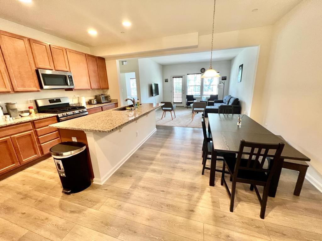 a kitchen and living room with a table and chairs at Waterfront escape 