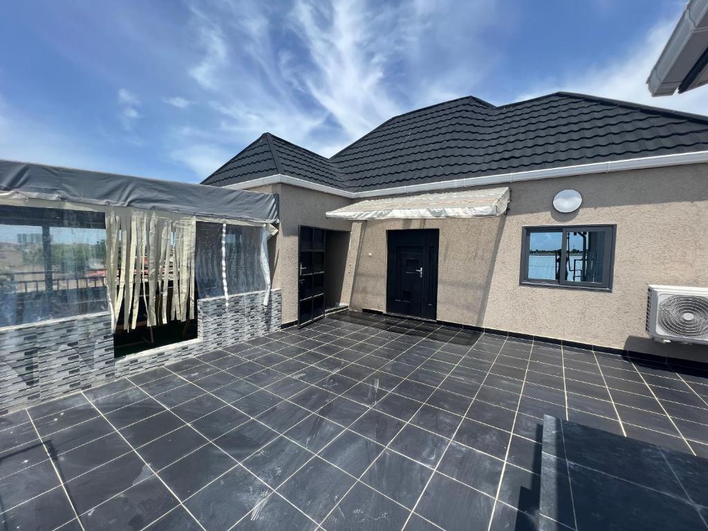 a patio in front of a house with a roof at S2A apparts in Lomé