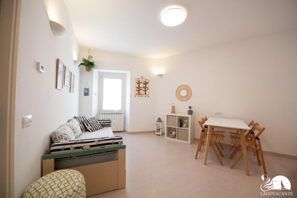 - un salon blanc avec une table et une chaise dans l'établissement La Colomba, à San Felice del Benaco