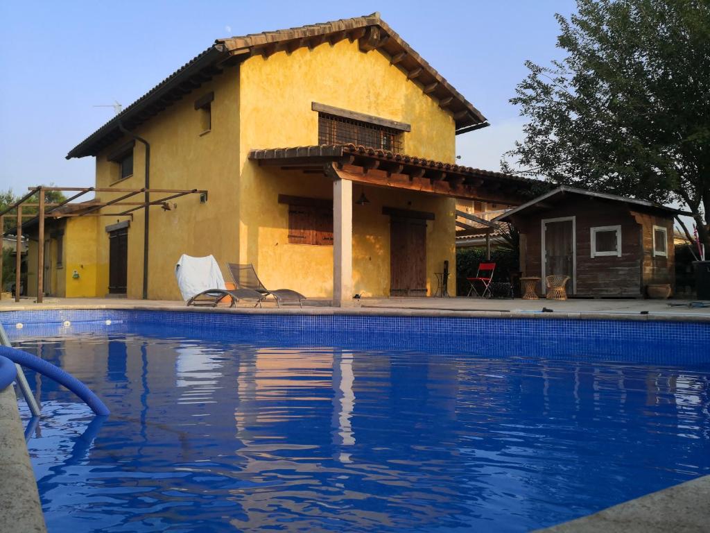 une maison avec une piscine en face de celle-ci dans l'établissement La Casa Amarilla, à Totana
