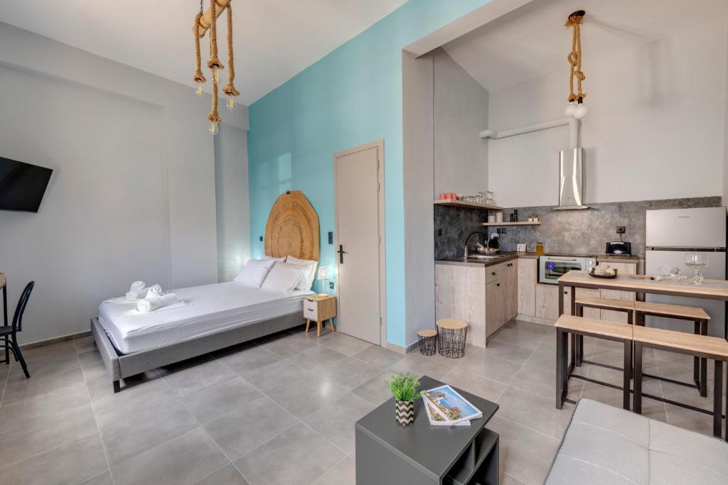 a living room with a bed and a kitchen at LUNA & TERRA APARTMENTS SYROS in Ermoupoli