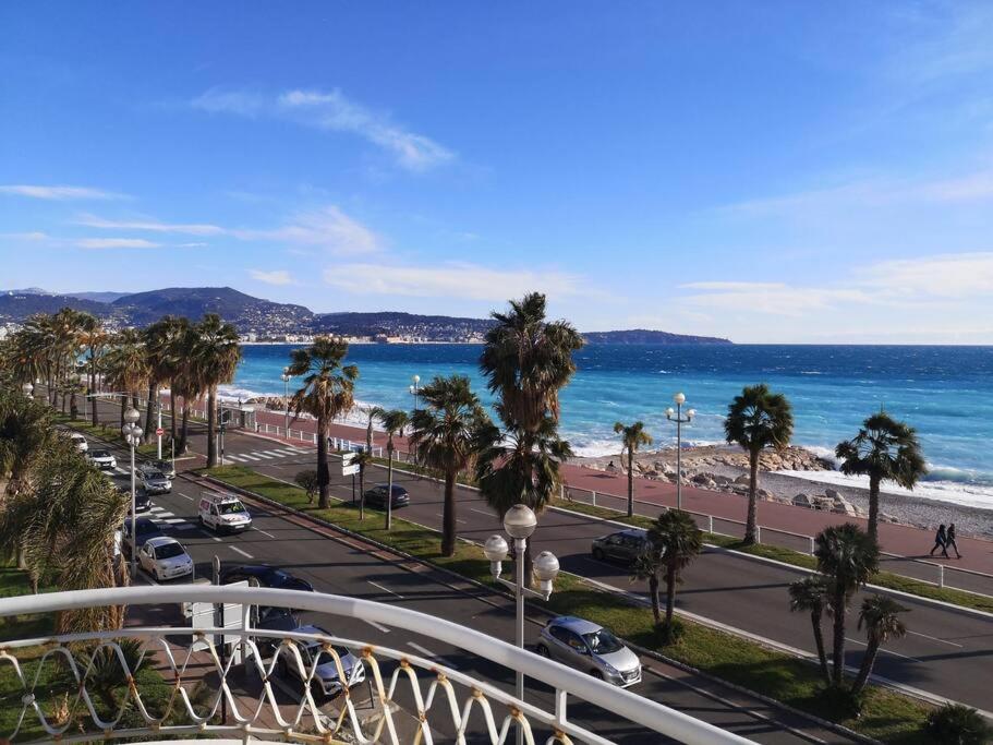 a view of the beach and the ocean from a balcony at Beach front, Superbe appartement pour 4 personnes in Nice