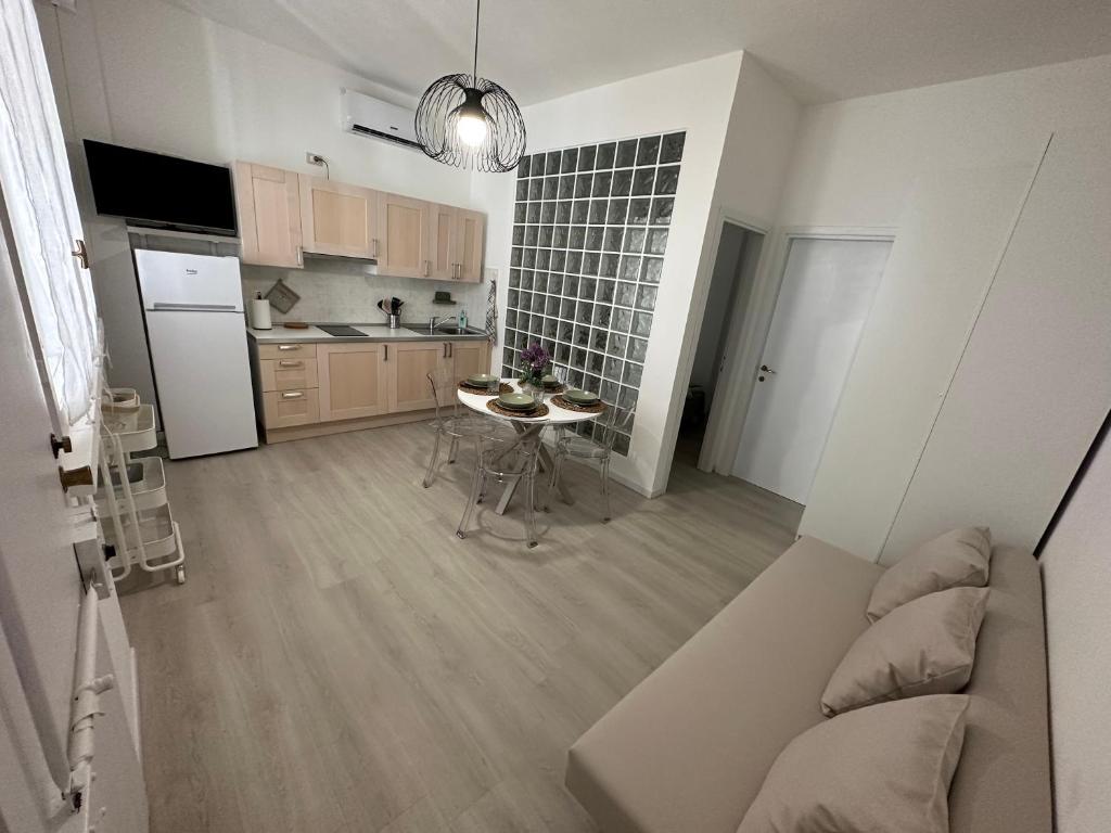 a kitchen with a couch and a table in a room at Monolocale Portoverde Beach in Misano Adriatico