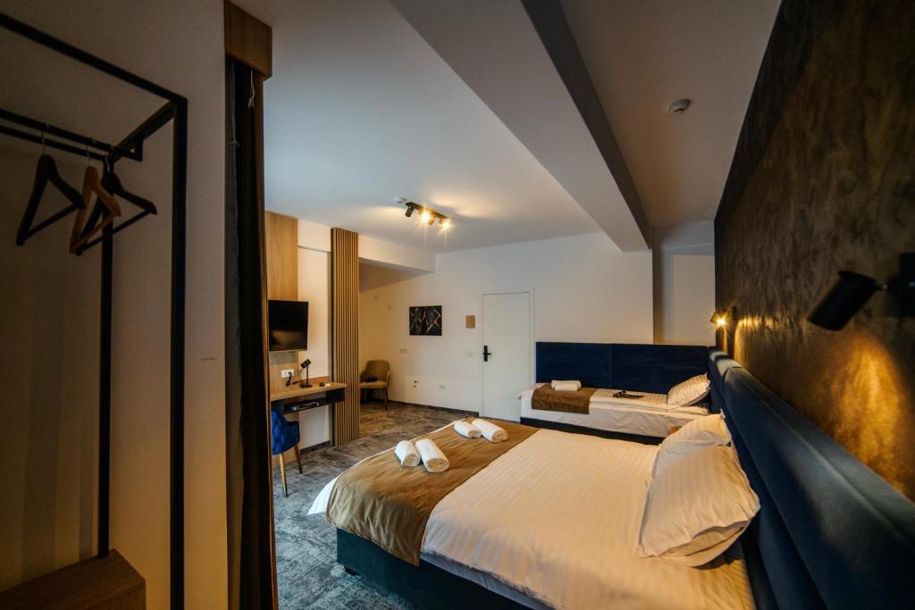 a hotel room with a large bed and a bathroom at GBU Home Timisoara in Timişoara