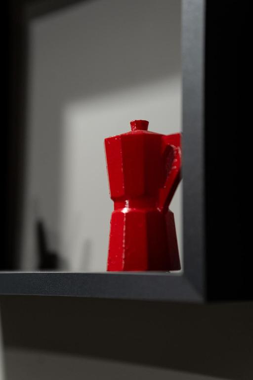 a red object is sitting on a shelf at Tiè tiè in Naples