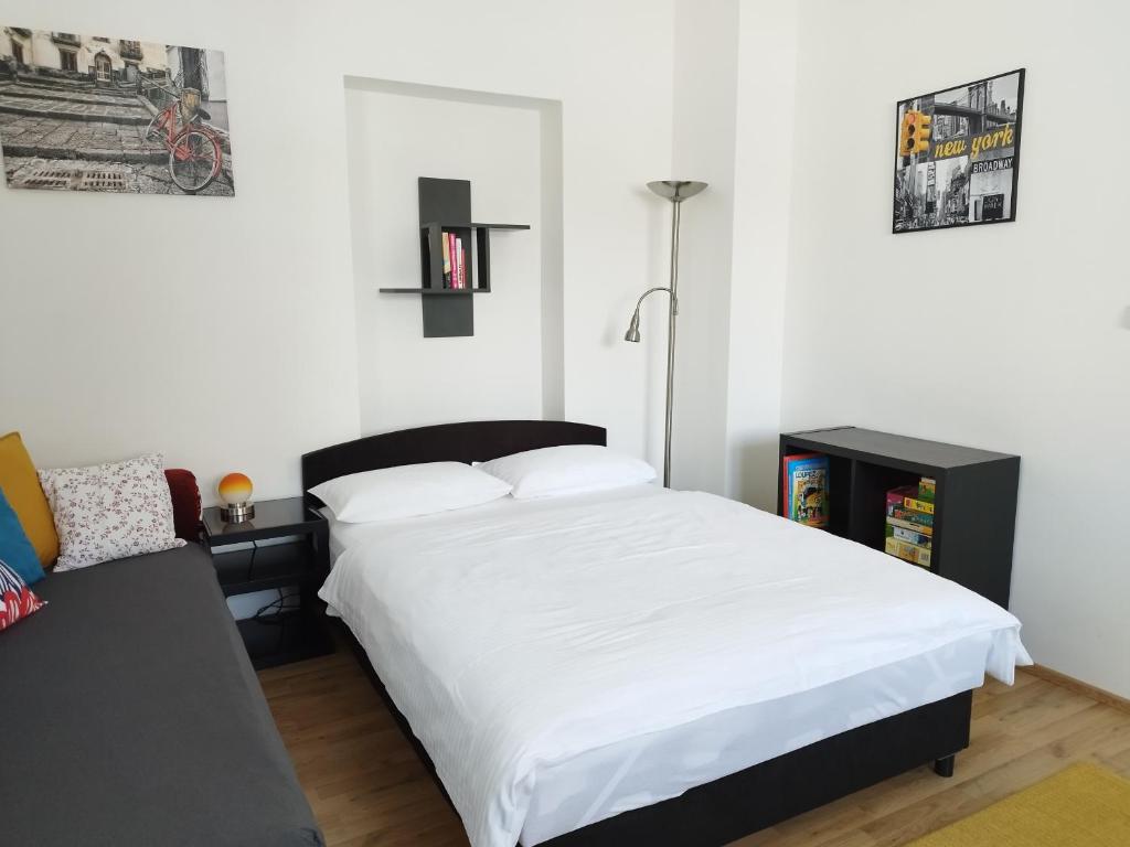 a bedroom with a large white bed and a desk at Stará Sázava in Sázava