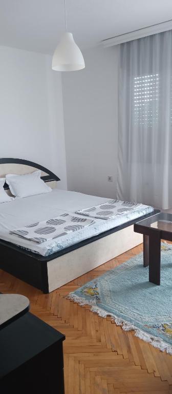 a bedroom with a large bed and a rug at Julija Guest House in Ohrid