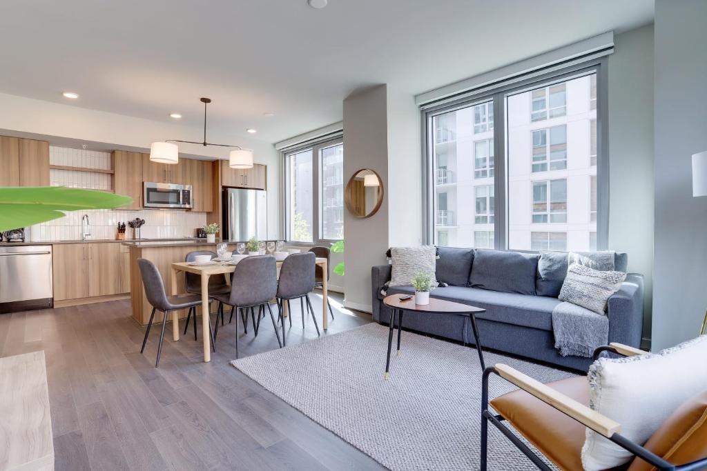 a living room and kitchen with a couch and a table at Stylish Condo at Clarendon with Rooftop Views in Arlington