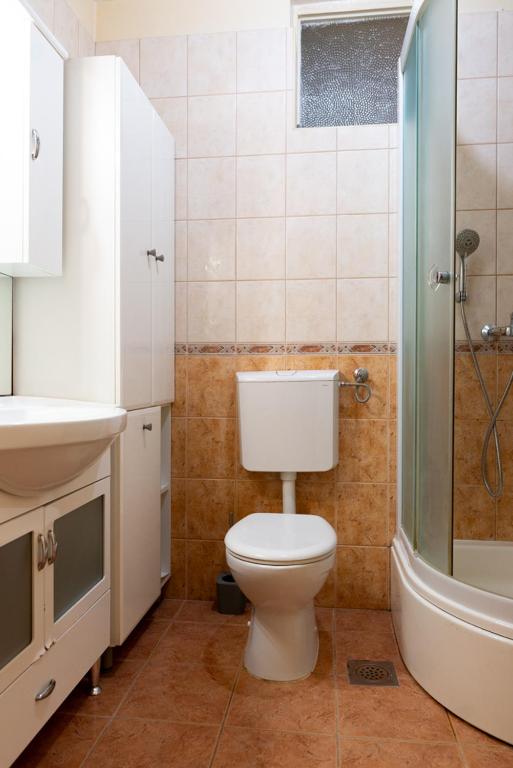 a bathroom with a toilet and a sink and a shower at Apartment Duje in Split