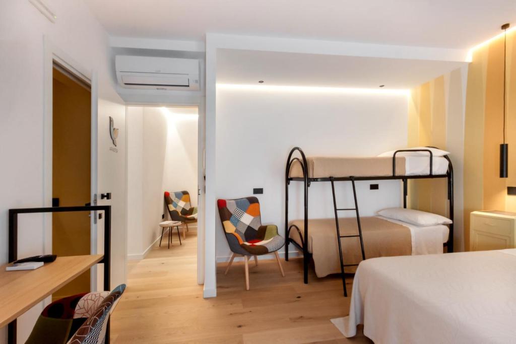 a bedroom with two bunk beds and a desk at La Sentina Experience in San Benedetto del Tronto