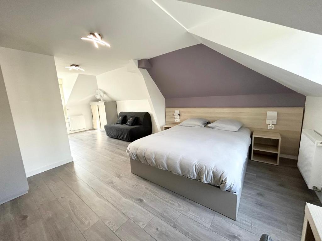 sypialnia na poddaszu z łóżkiem i kanapą w obiekcie 12.Studio#Creteil#Loft#Cinéma#Exclusif w mieście Créteil