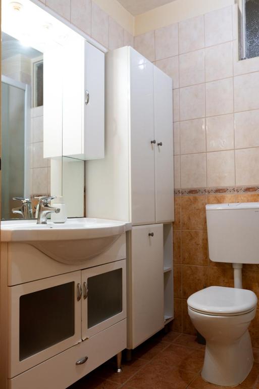 a bathroom with a white sink and a toilet at Apartment Duje in Split