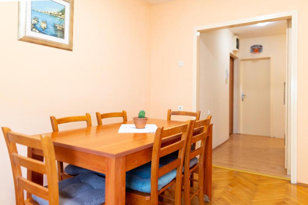 a dining room with a wooden table and chairs at Apartment Duje in Split