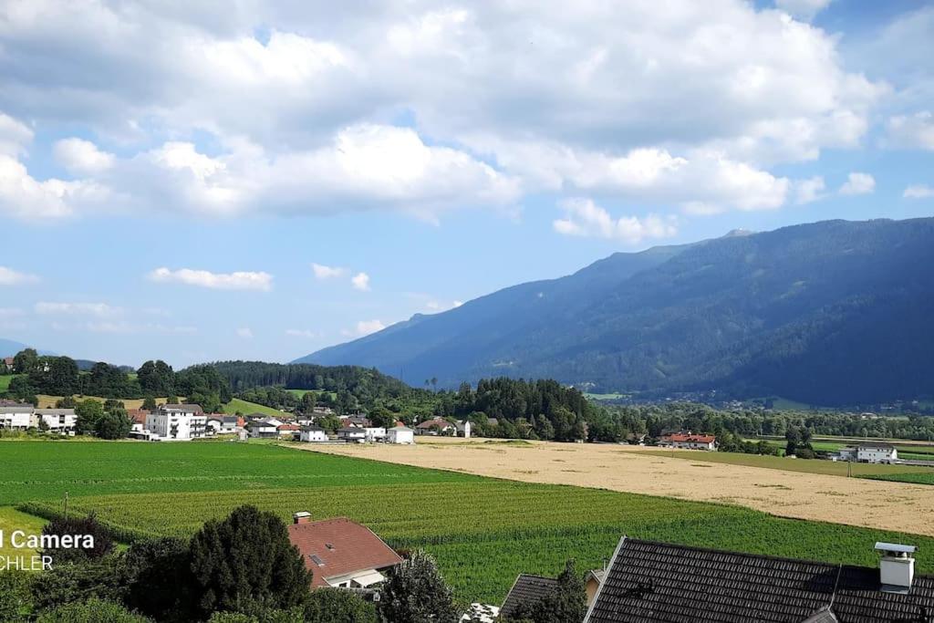 a view of a field with mountains in the background at Apartment mit Terrasse und Bergblick in Lendorf