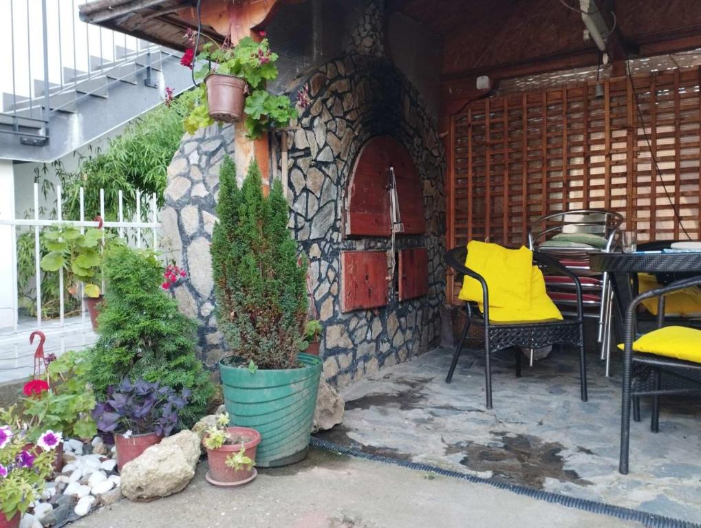 a patio with a table and chairs and plants at Dana in Trnava