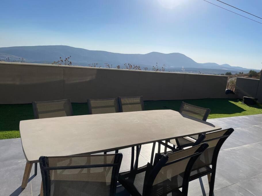 a white table and chairs on a patio at יוקרה בגליל in Biriyya