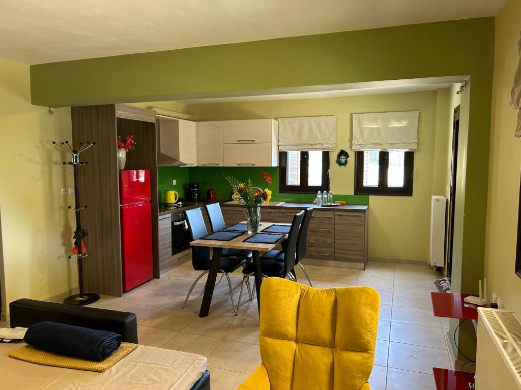 a kitchen with a table and a red refrigerator at Sunshine apartment in Ioannina