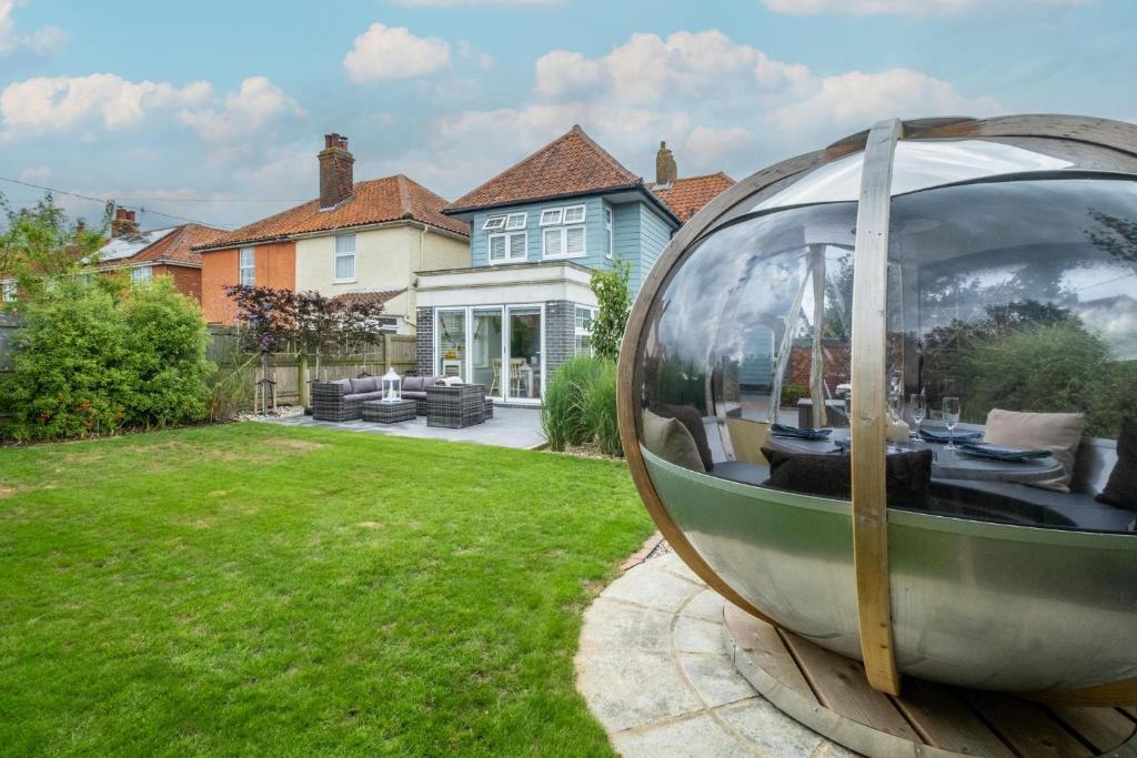 a large glass orb sitting in the yard of a house at 69 Saxmundham Road in Aldeburgh
