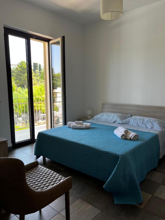 a bedroom with a bed with two towels on it at Dimora Di Bari in Selva di Fasano