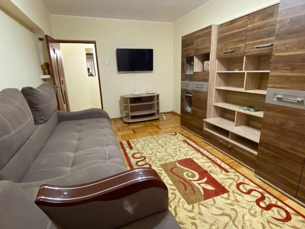 a living room with a couch and a flat screen tv at Apartment for rent in Galaţi