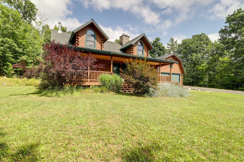 a log home with a large yard in front of it at Stellar Wilmington House on 20 Wooded ADK Acres! in Wilmington