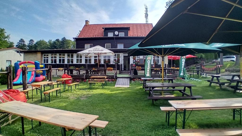 a group of tables and benches in front of a building at Chata Jahodná in Košice