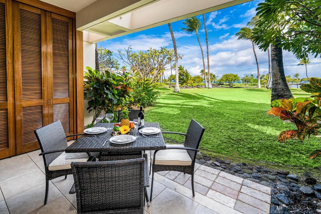 a dining table and chairs on a patio at Mauna Lani Terrace J101 in Waikoloa