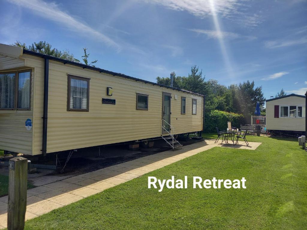a rv rental trailer sitting in a yard at Rydal Retreat Lakeland Holiday Park in Flookburgh