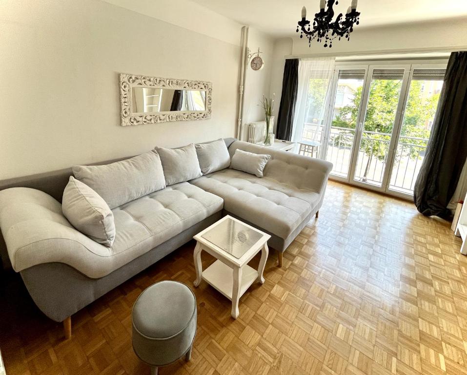 a living room with a couch and a table at CH Apartment Lausanne Gare in Lausanne