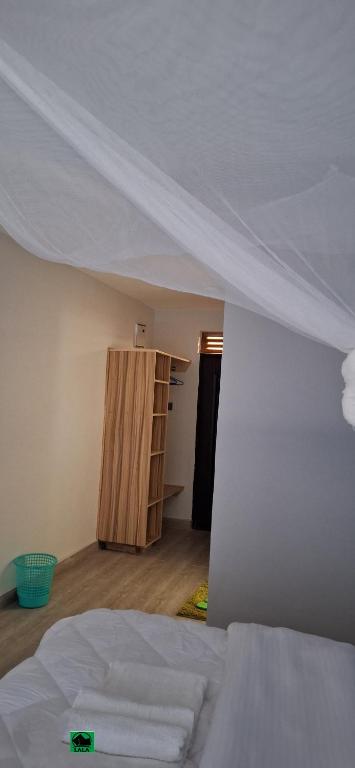 Postel nebo postele na pokoji v ubytování Lala Inn Kikopey