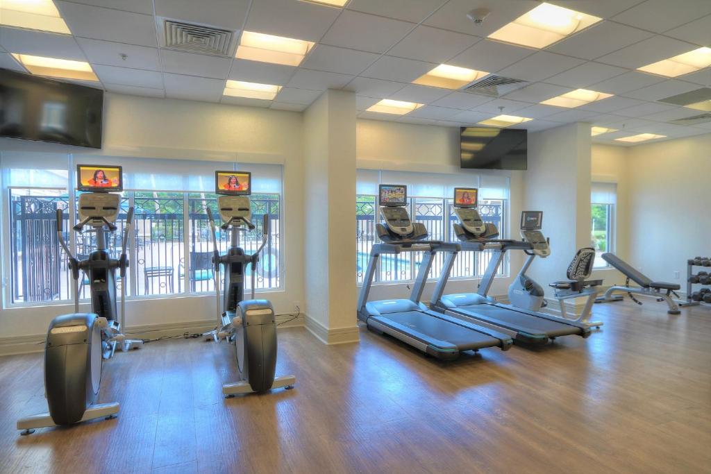 a gym with treadmills and exercise bikes in a room at Holiday Inn Express Hotel & Suites Mobile Saraland by IHG in Saraland