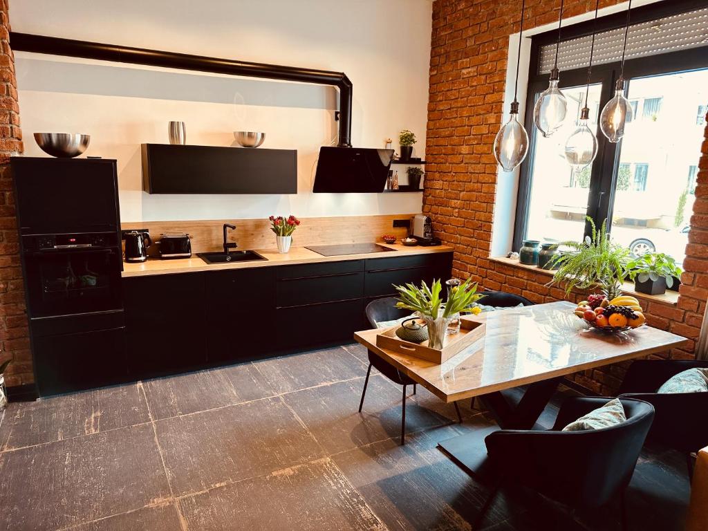 a kitchen with a table and a counter top at holidayAHRpartment in Bad Neuenahr-Ahrweiler