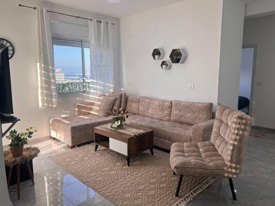a living room with a couch and a table at חורי 20 דירה 29 in Haifa