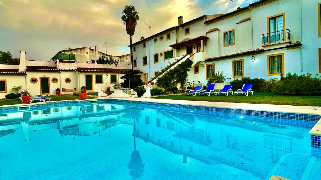 a large swimming pool in front of a house at Casa do Colegio Velho in Vila Viçosa