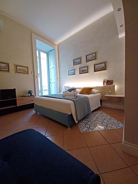 a large bedroom with a bed and a television at Domus Duomo B&B Napoli in Naples