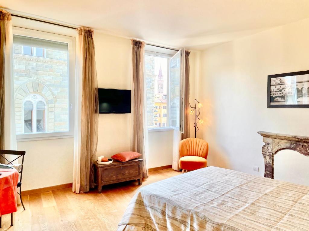 a bedroom with a bed and a large window at Signoria's Suite in Florence