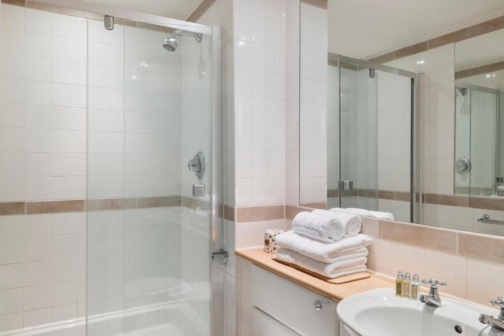 a bathroom with a shower and a sink and a mirror at SACO Bristol West India House in Bristol