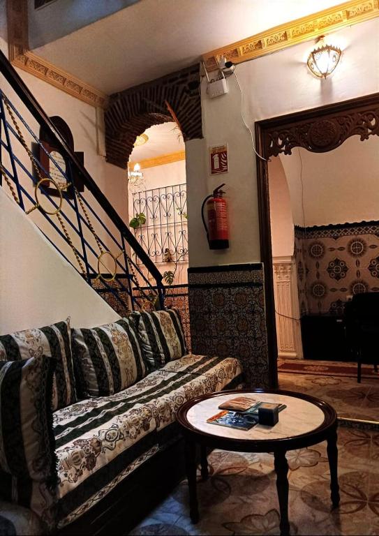 a living room with a couch and a table at Dar Mora in Tangier