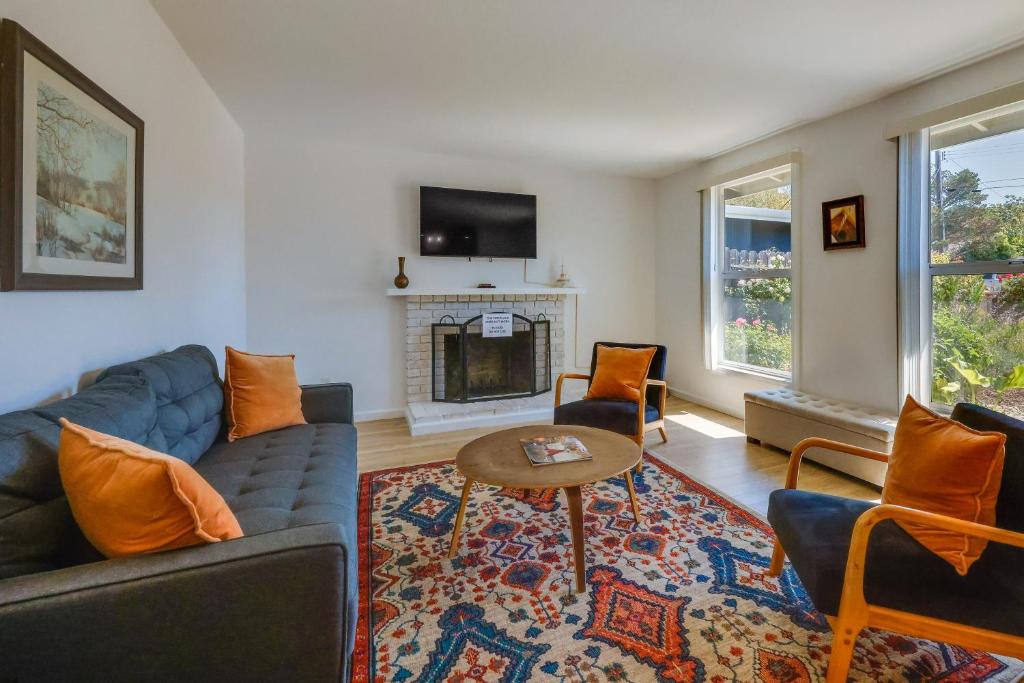 a living room with a blue couch and a fireplace at Inviting Home with Patio Walk to Downtown Novato! in Novato