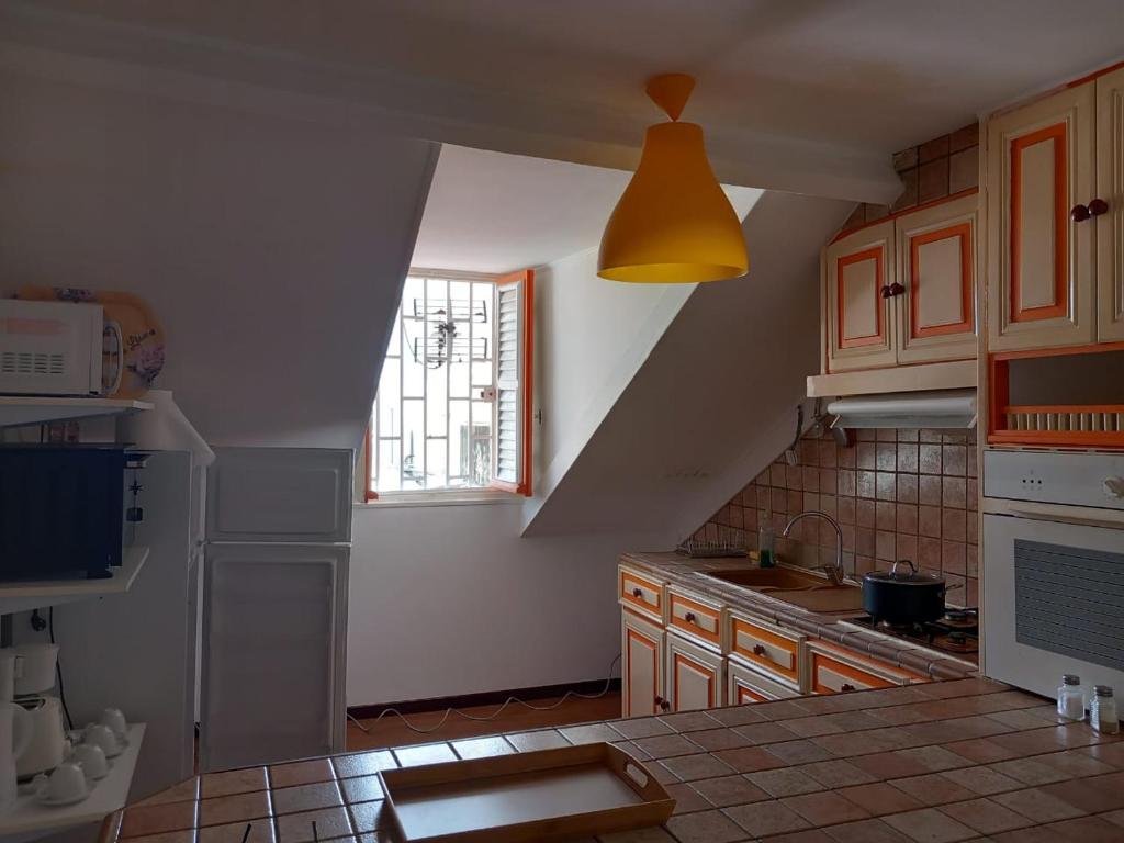 a kitchen with a sink and a yellow light at Victory Locations in Fort-de-France
