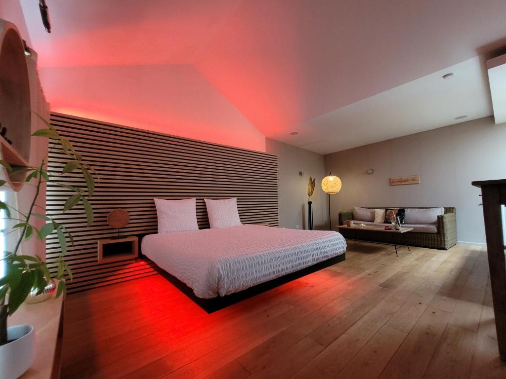 a bedroom with a bed with a red light at La bulle D'orée in Chaudfontaine
