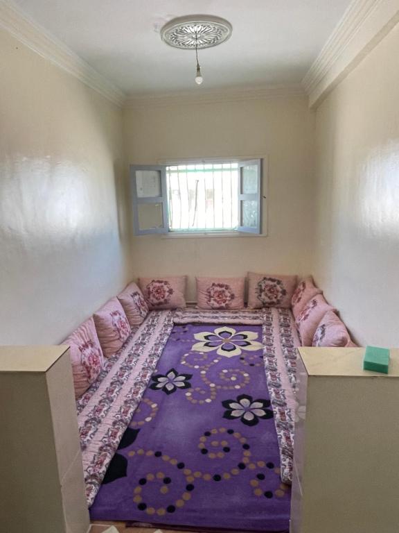 a living room with a couch and a purple rug at حي لمسيرةا شارع الحيط in Tarfaya