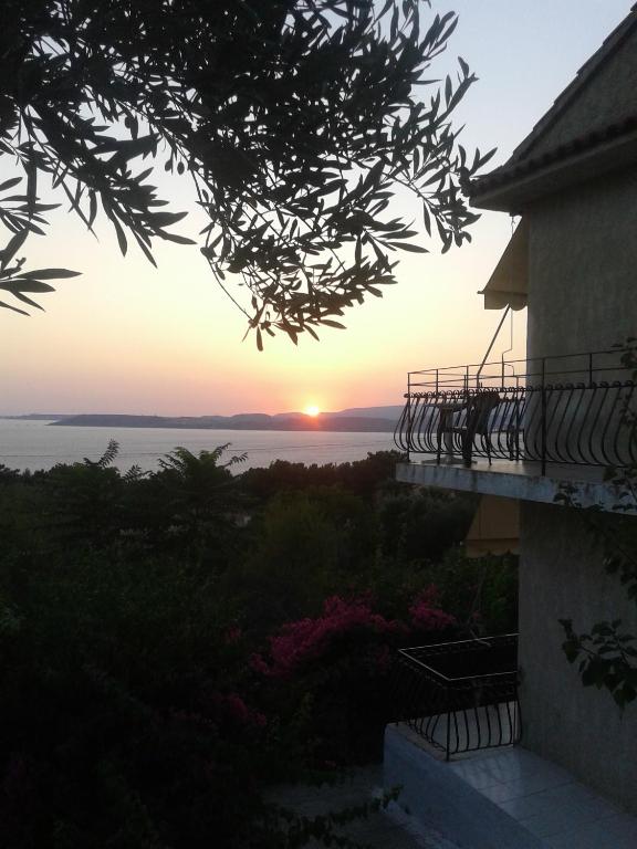 a view of the sunset from the balcony of a house at Raymondos Apartments in Lassi