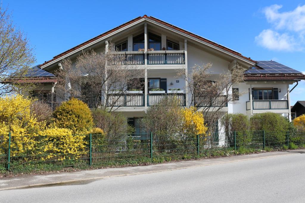 a house with a balcony on the side of the road at Ferienappartement Austen in Piding