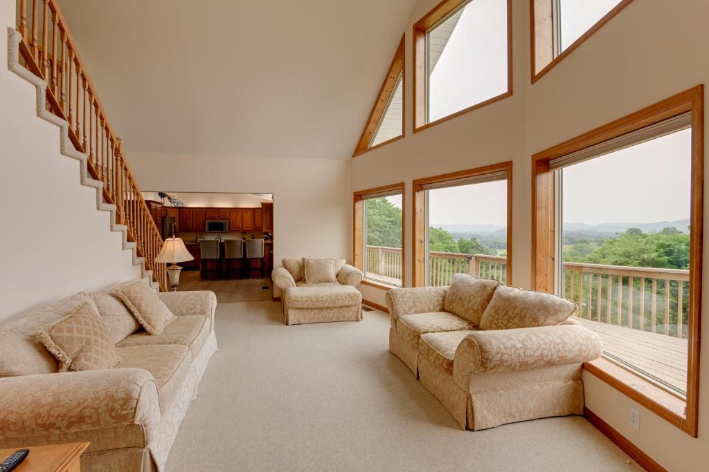 a large living room with two couches and windows at Gordonsville Retreat Deck with Spectacular Views! in Gordonsville