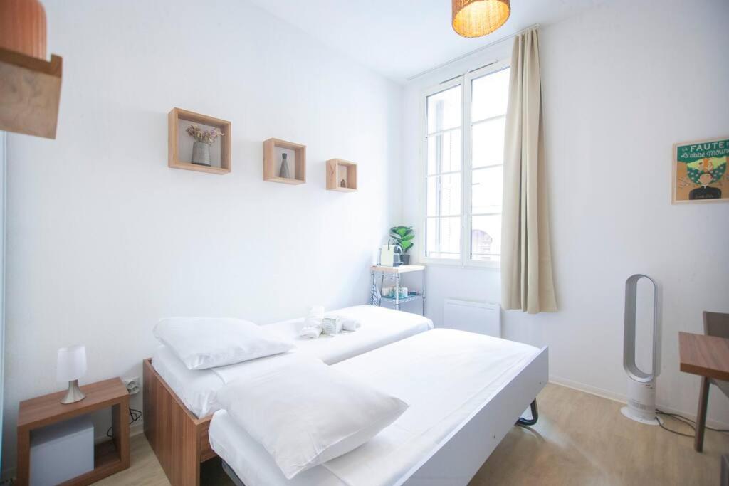 a white room with two beds and a window at SENAC - Havre citadin, La Canebière in Marseille