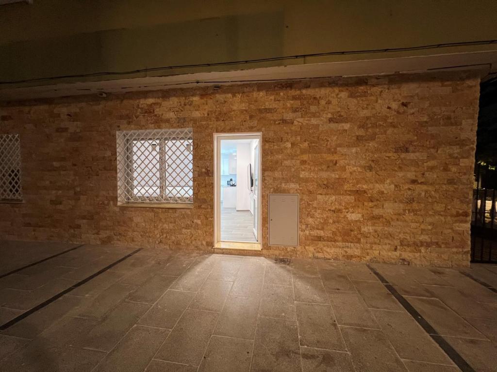 an empty room with a brick wall and a door at Apartamentos BEACHYDAYS Metropolis B in Torremolinos
