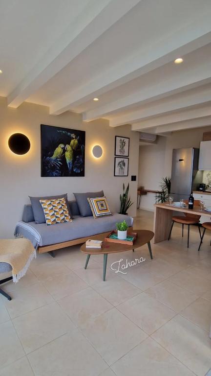 a living room with a blue couch and a table at Creta Spirit in Plakias
