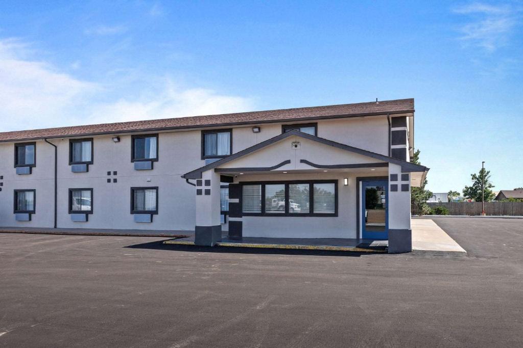 a large white building with a lot of windows at Motel 6 Brighton CO Denver Northeast in Brighton